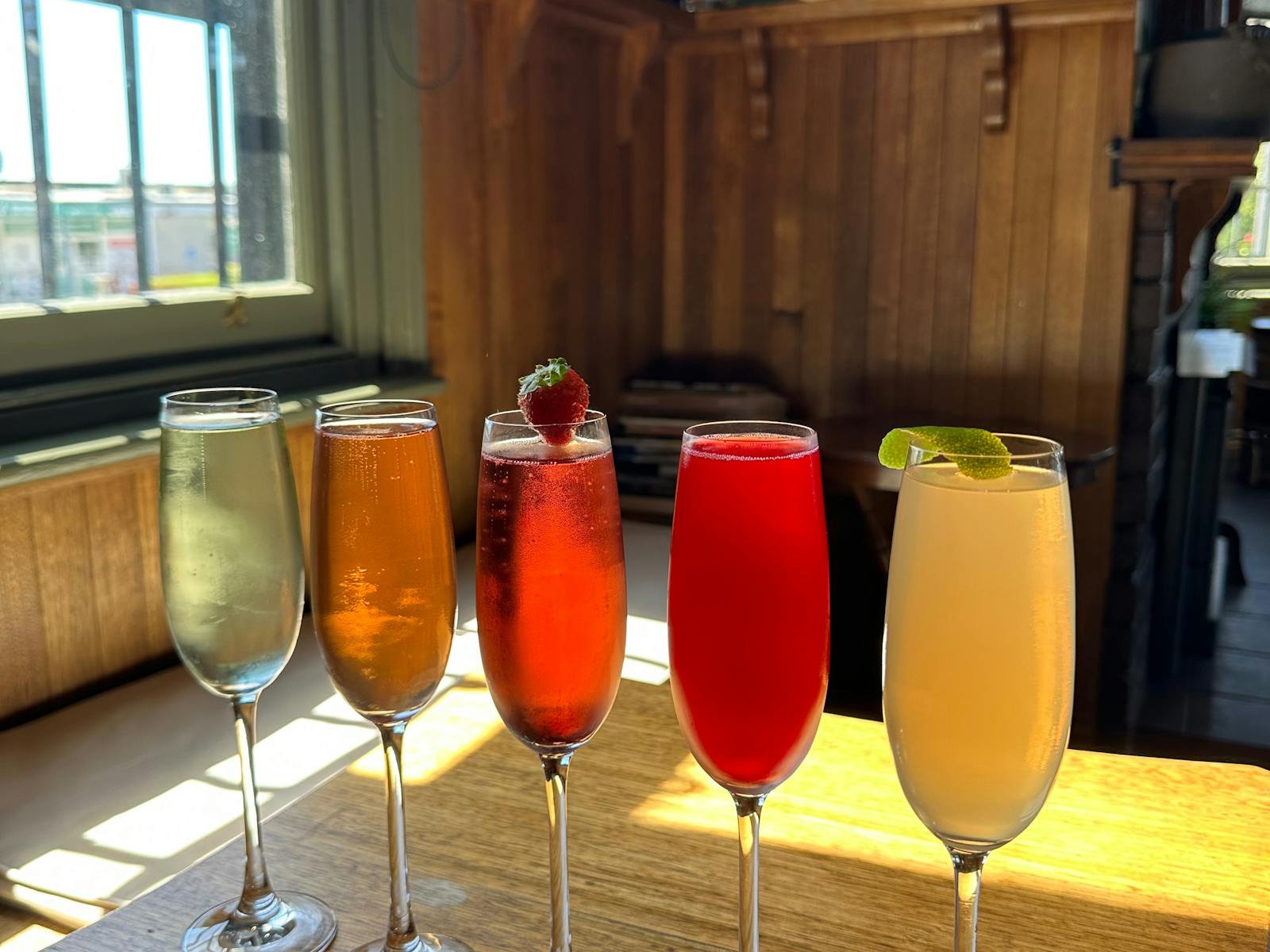 This photo is of our five sparkling cocktails in champagne glasses