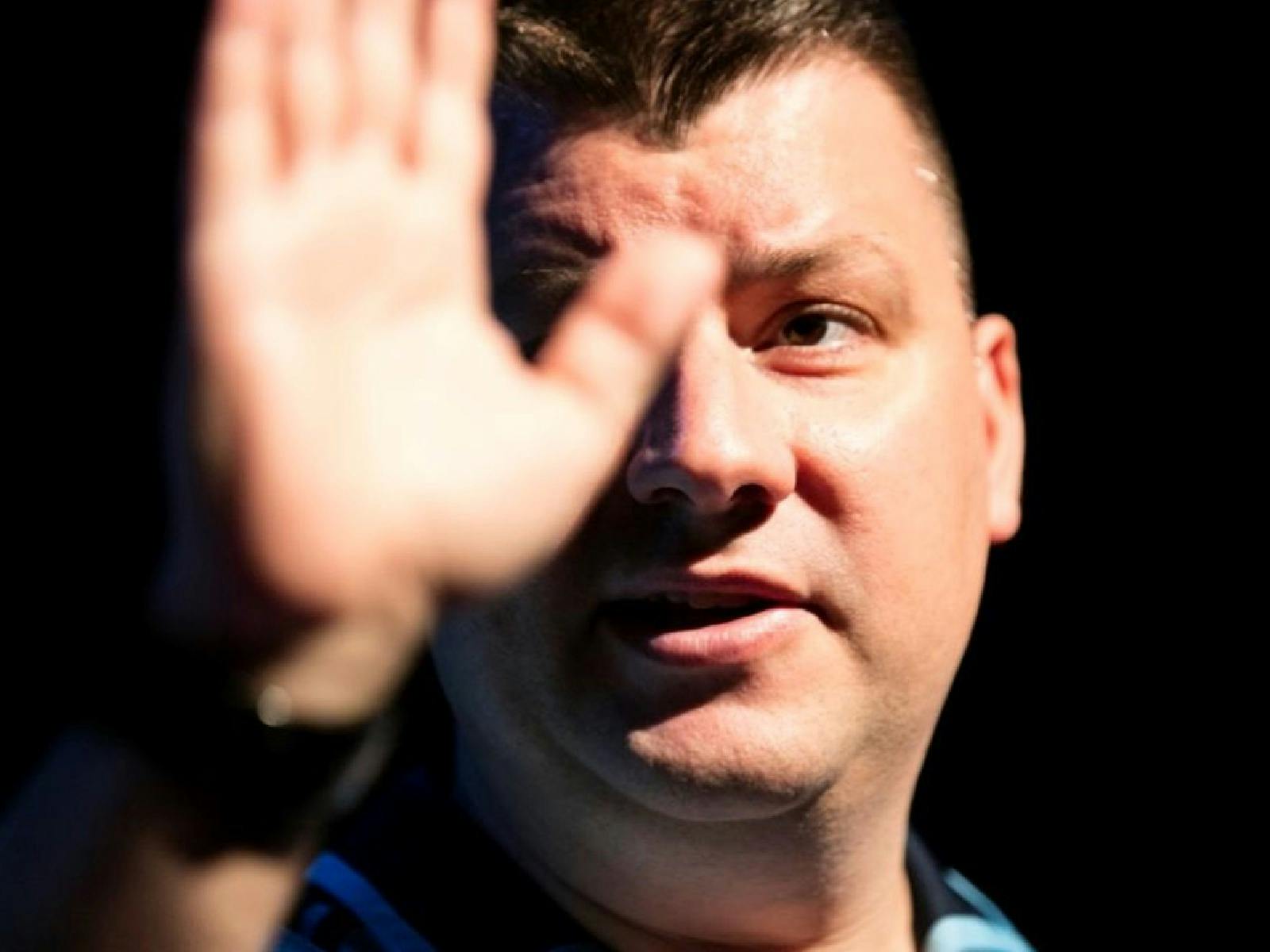 Close up of a man holding up his hand