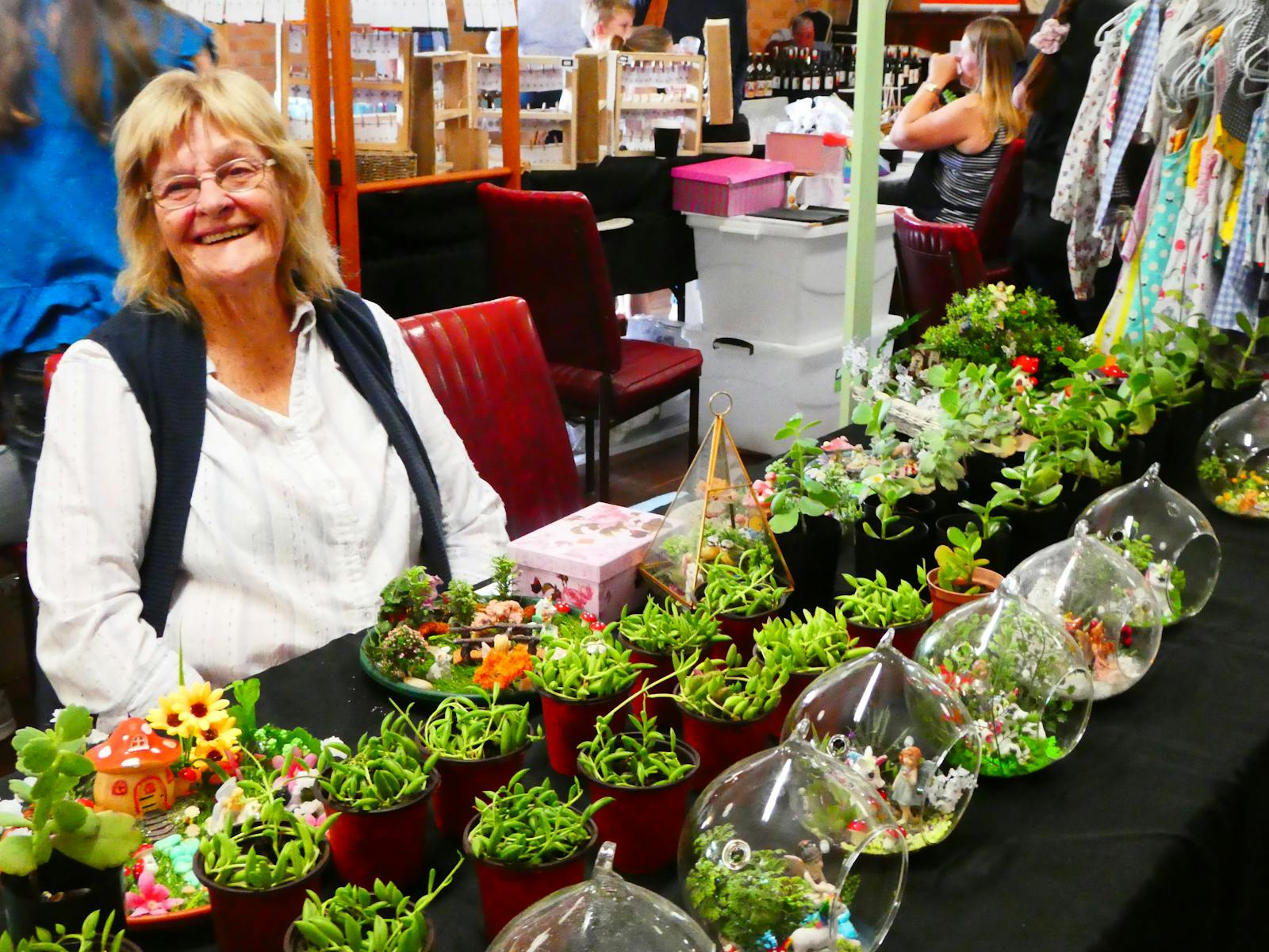 stallholder with plant creations at a stall