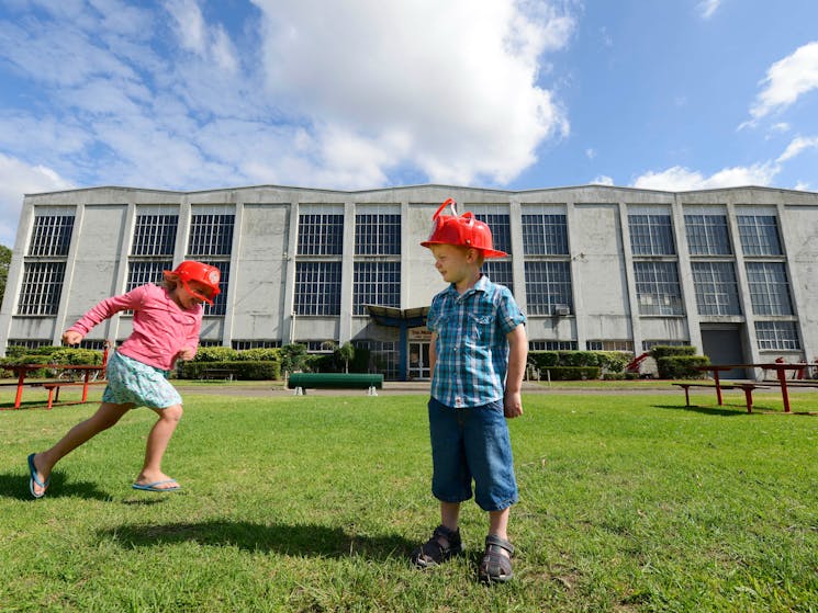 2 children on the grounds playing outside of the Museum