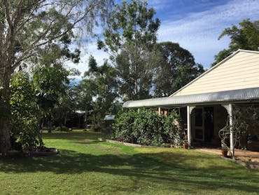 photo showing part of the cottage verandah and a grassed area outside