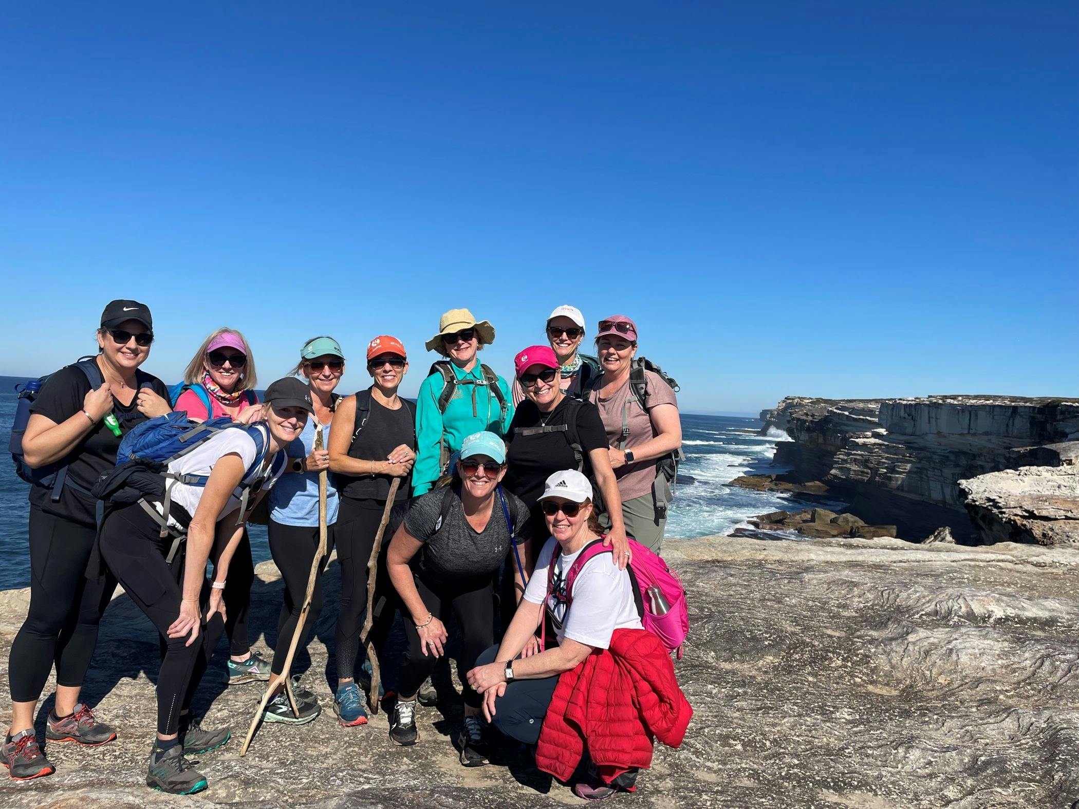 Smiling group hiking Sydney's coastline
