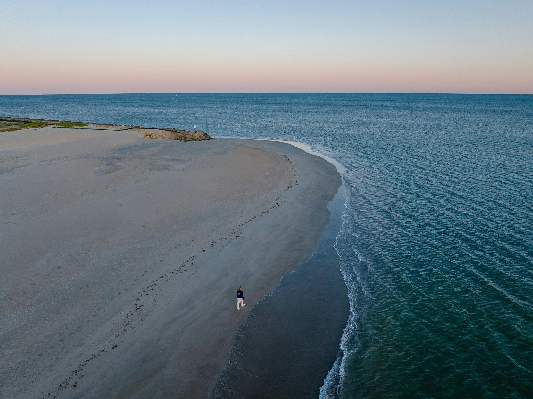 women walking along Town Beach in Mandurah at sunset