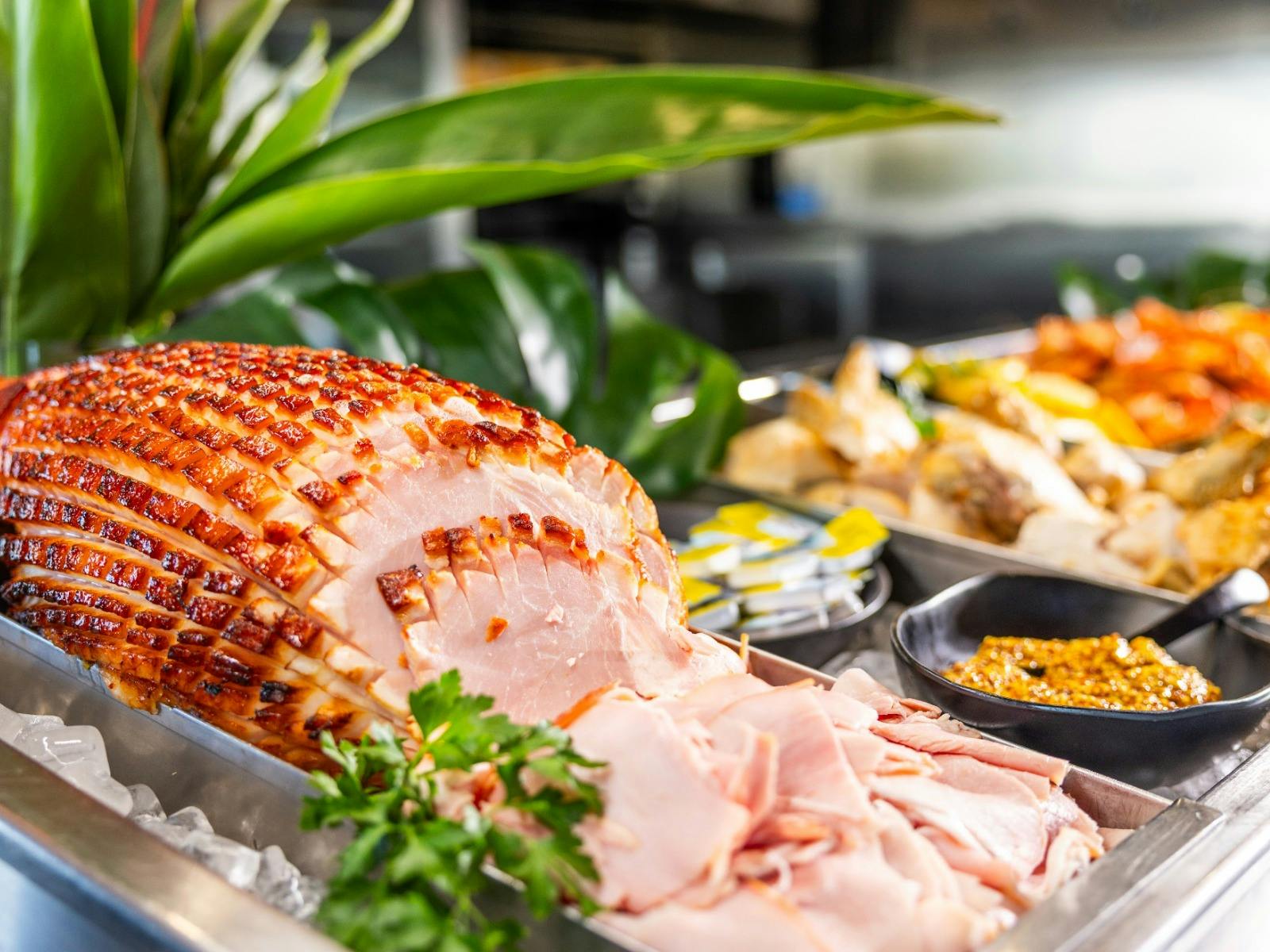 Baked ham on display at a buffet lunch.