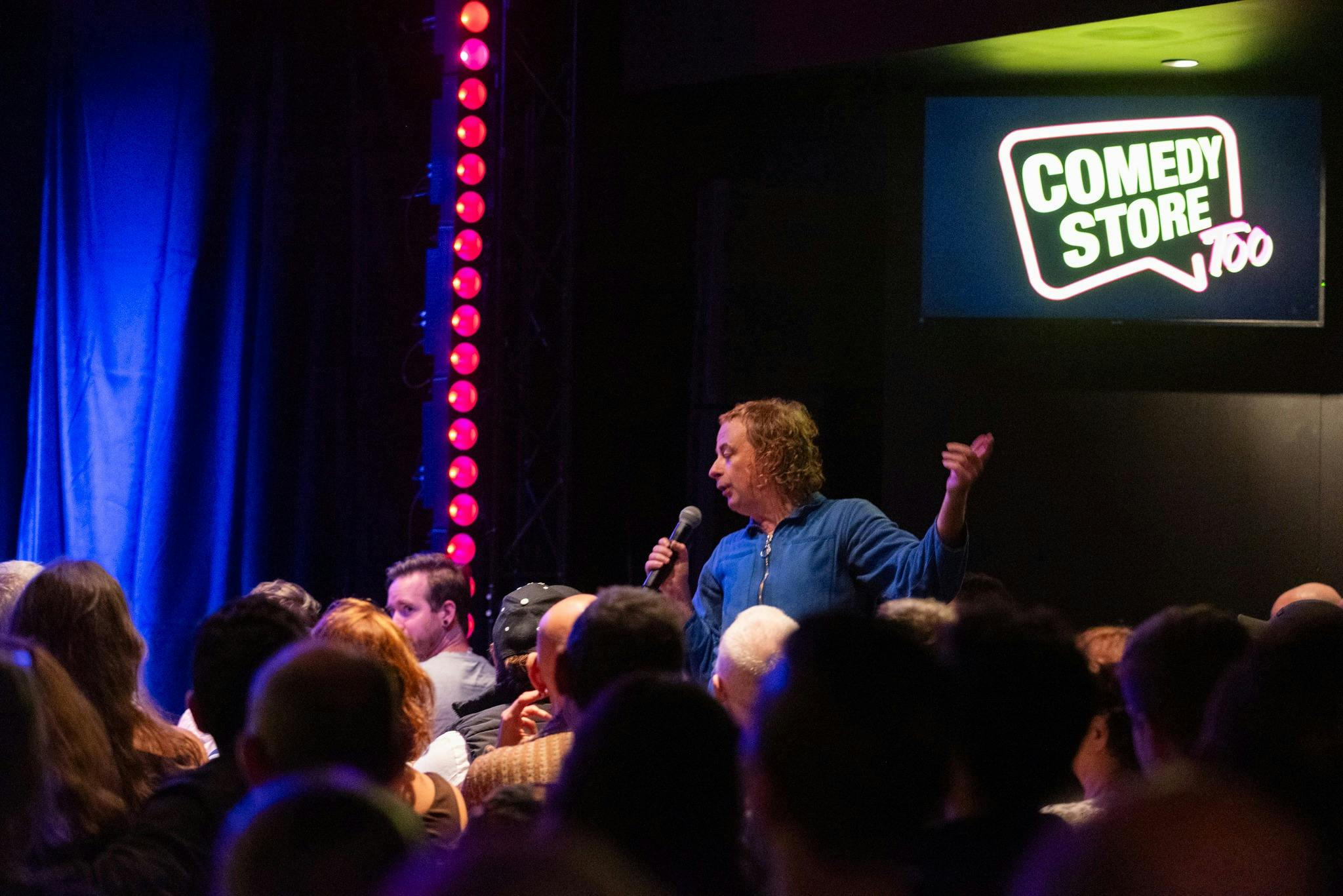 Live comedy performance taking place at The Comedy Store theatre.