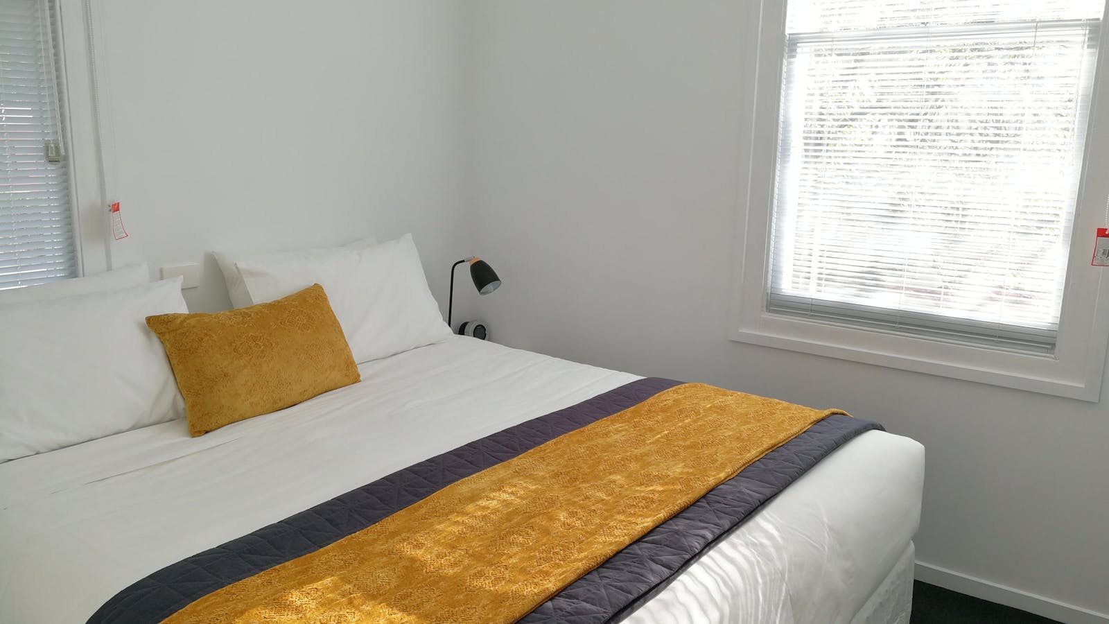 Second bedroom configuration: king bed (shown) or two single beds.