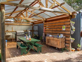 BBQ shed  adjacent to paved courtyardd