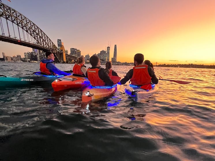 Huddling together to take in the stunning dusk colours of Sydney Harbour