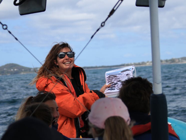 whale watching boat tour guide doing a presentation