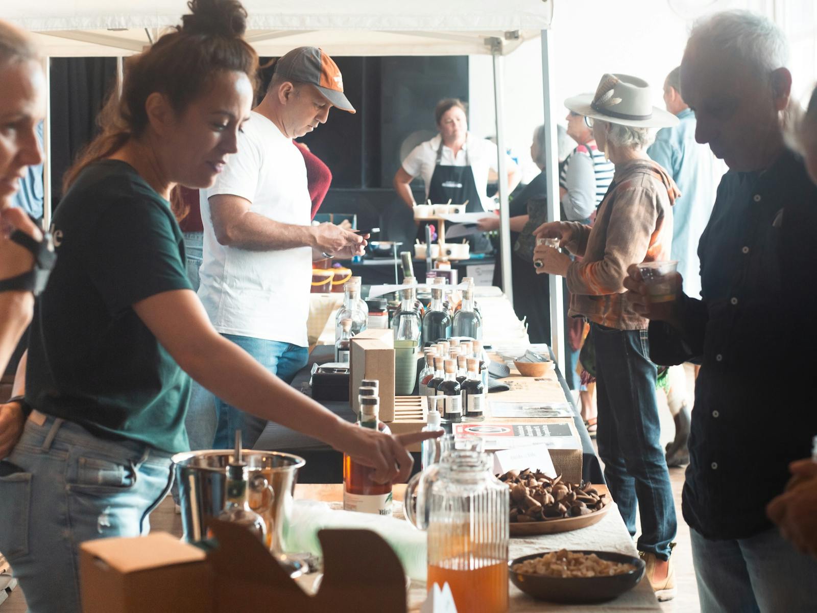 Woman showcasing her local rum and its ingredients to a man