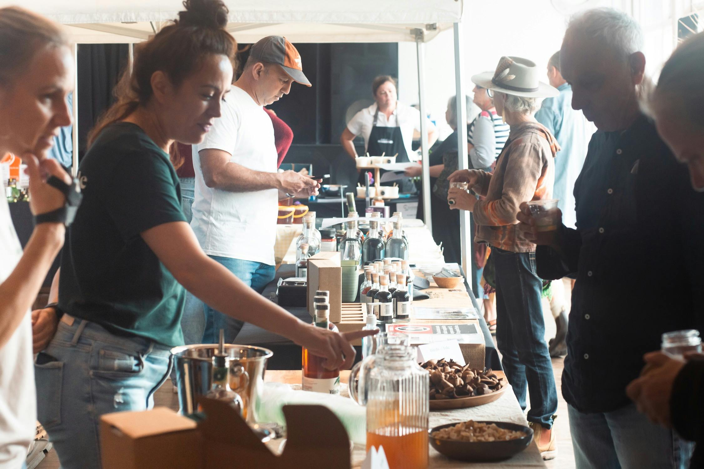 Woman showcasing her local rum and its ingredients to a man