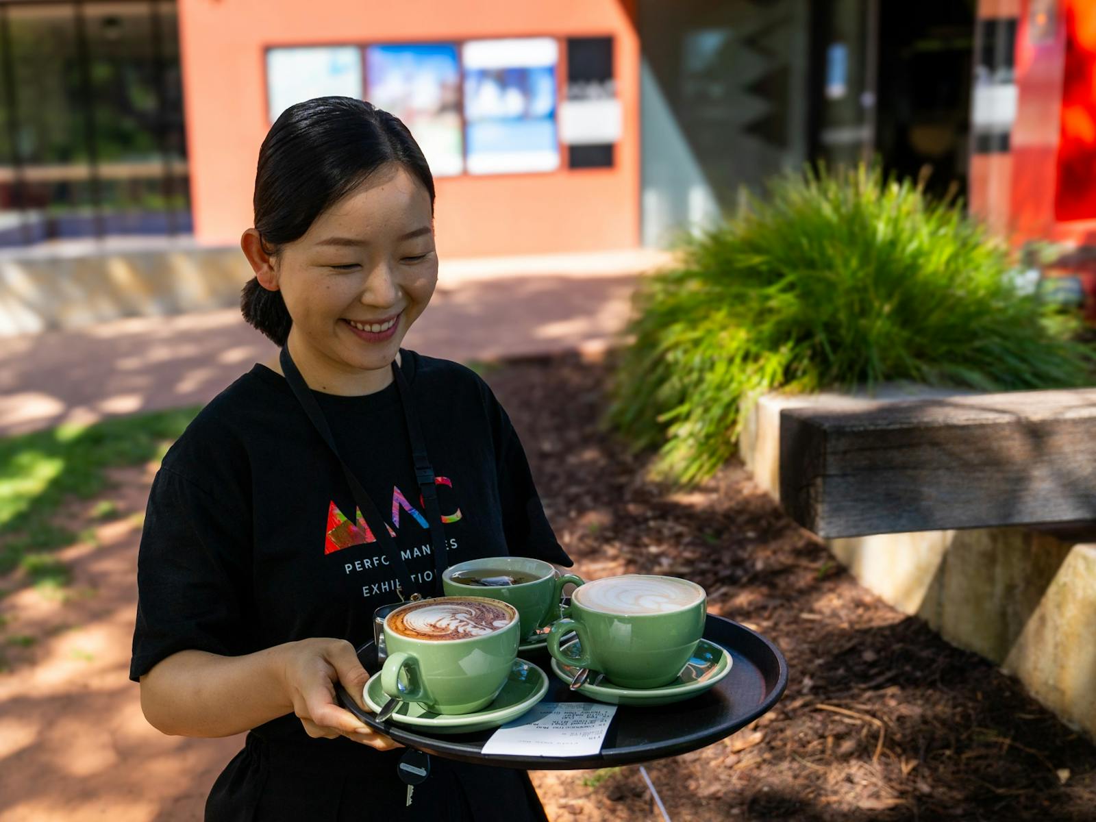 female, serving coffees outside