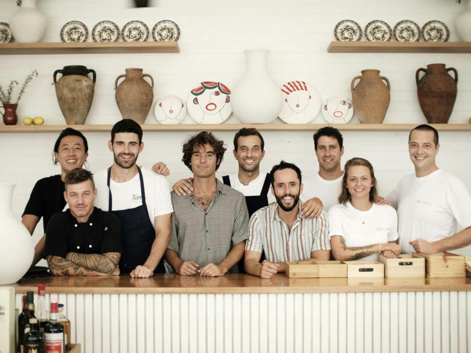 Staff at The Hut behind a white counter