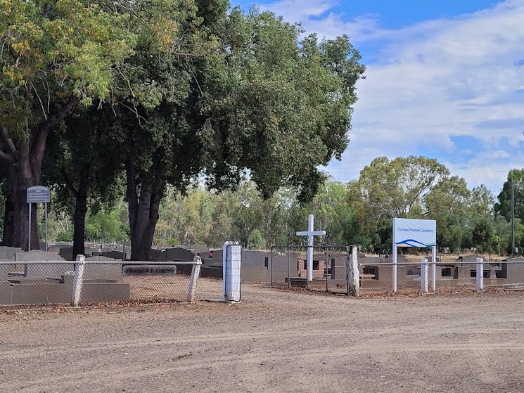 The entrance to Corowa's Pioneer Cemetery. The cemetery is shaded with large trees.