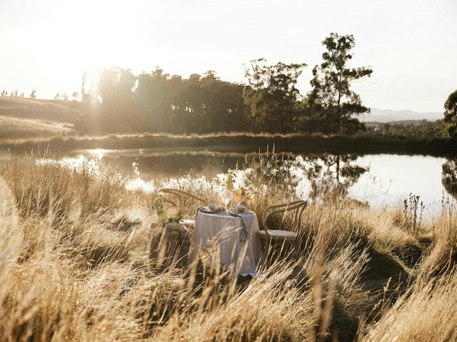 Small table & 2 chairs with wine  by the dam