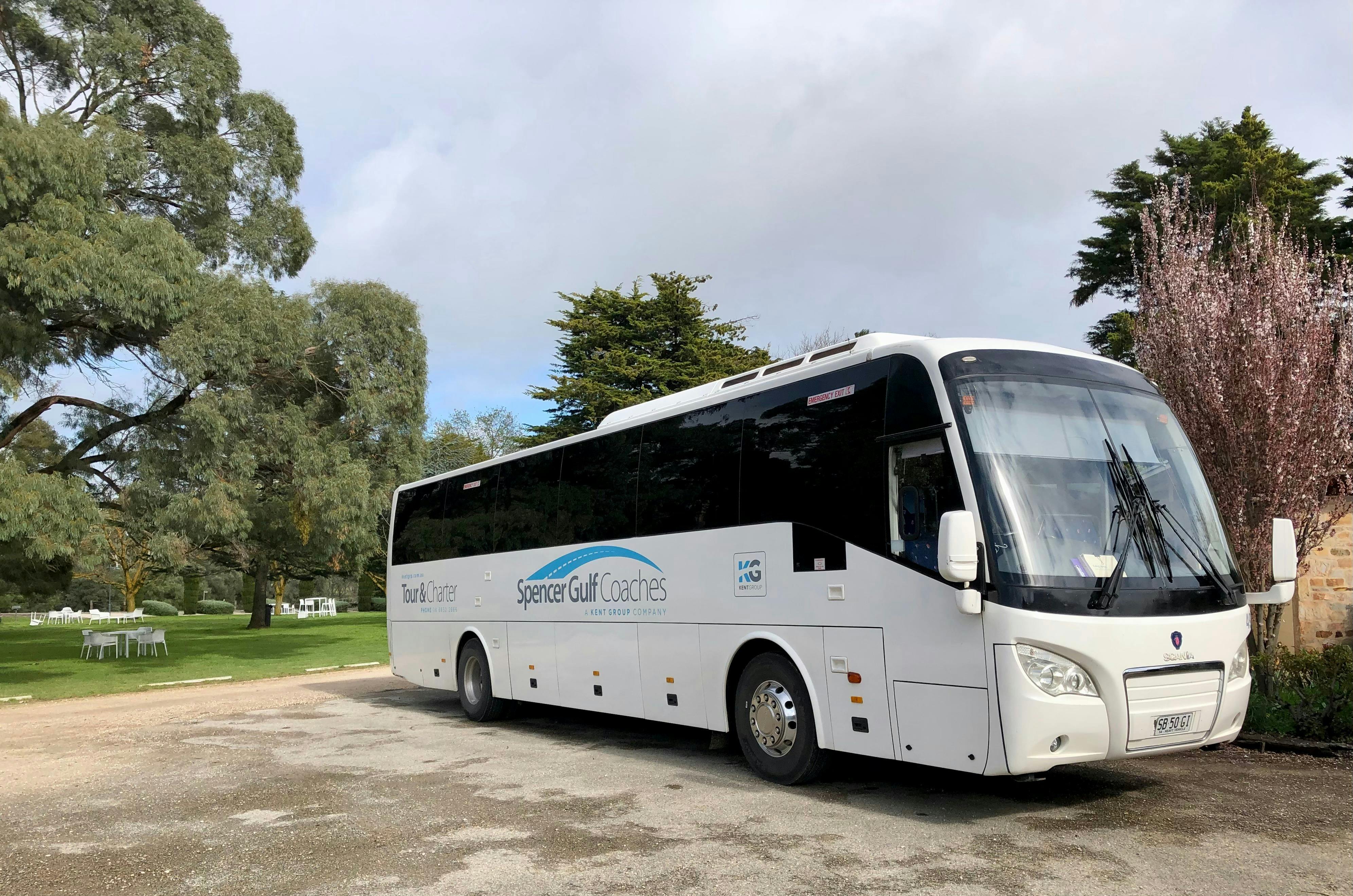 Large bus with trees in background