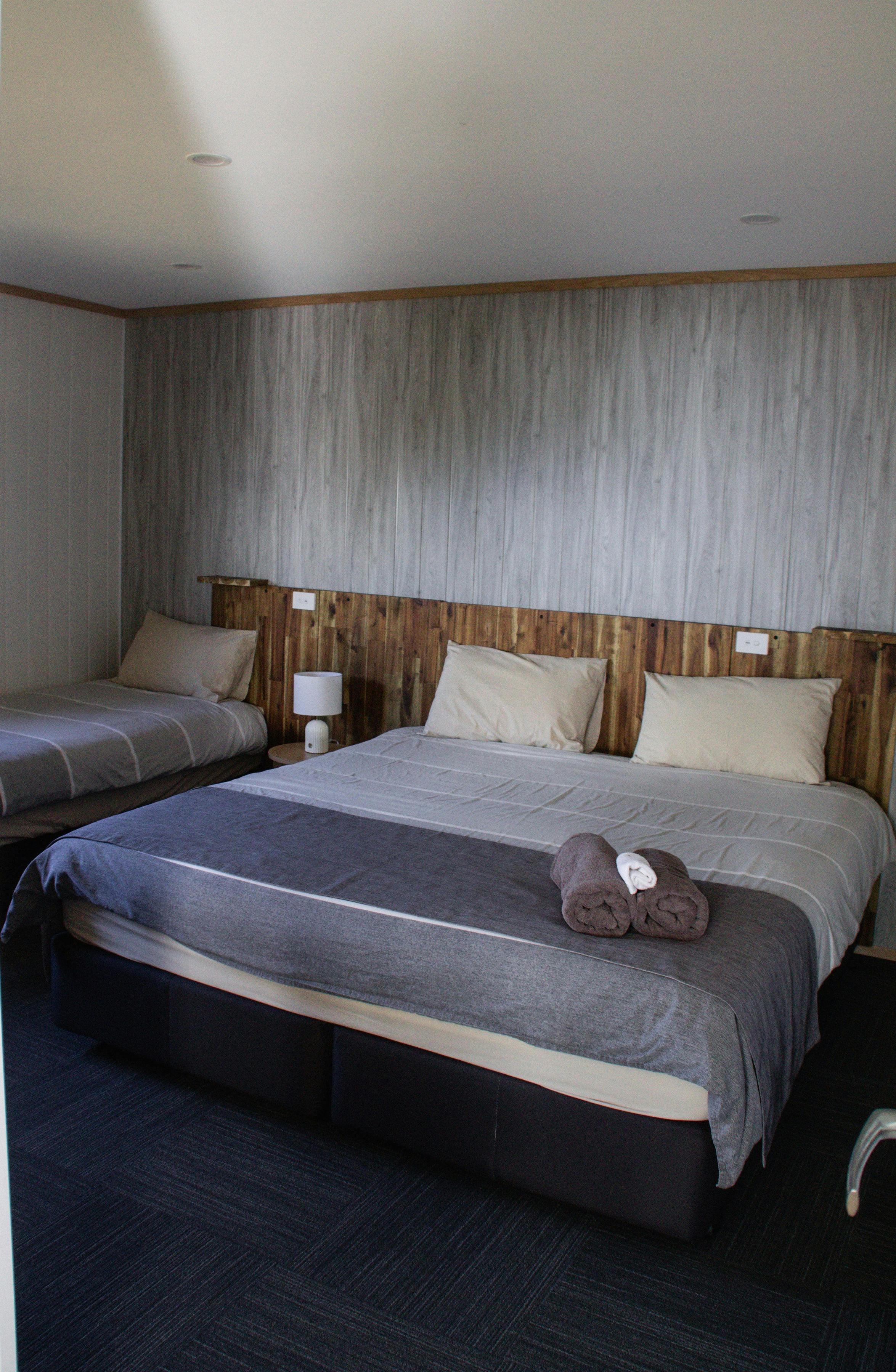 Comfortable bedroom with a double bed and natural timber interior