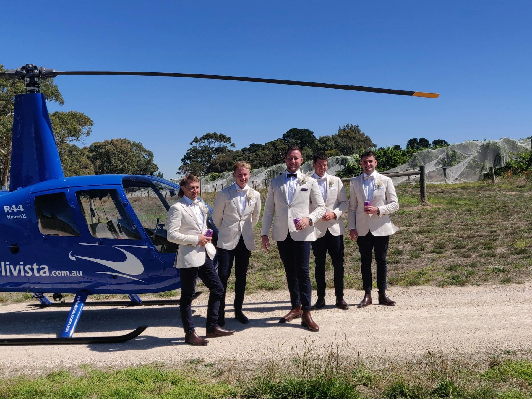 Groom and wedding party fling in to wedding