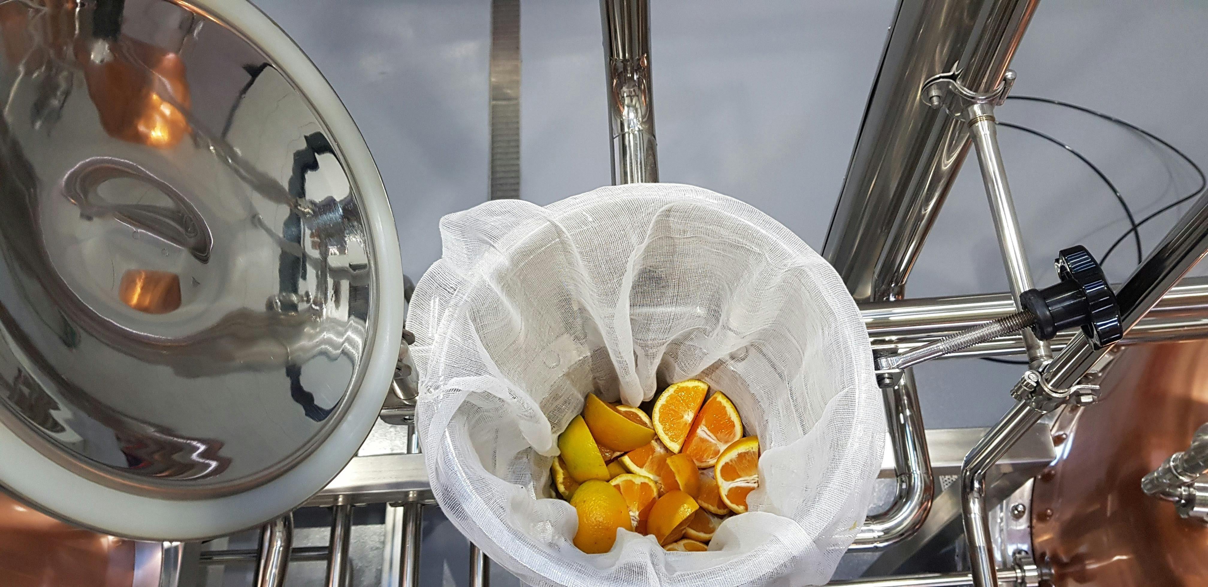 Adding oranges to the vapour basket to make our High Street Dry Gin