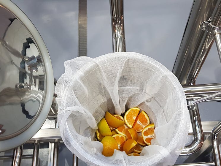 Adding oranges to the vapour basket to make our High Street Dry Gin