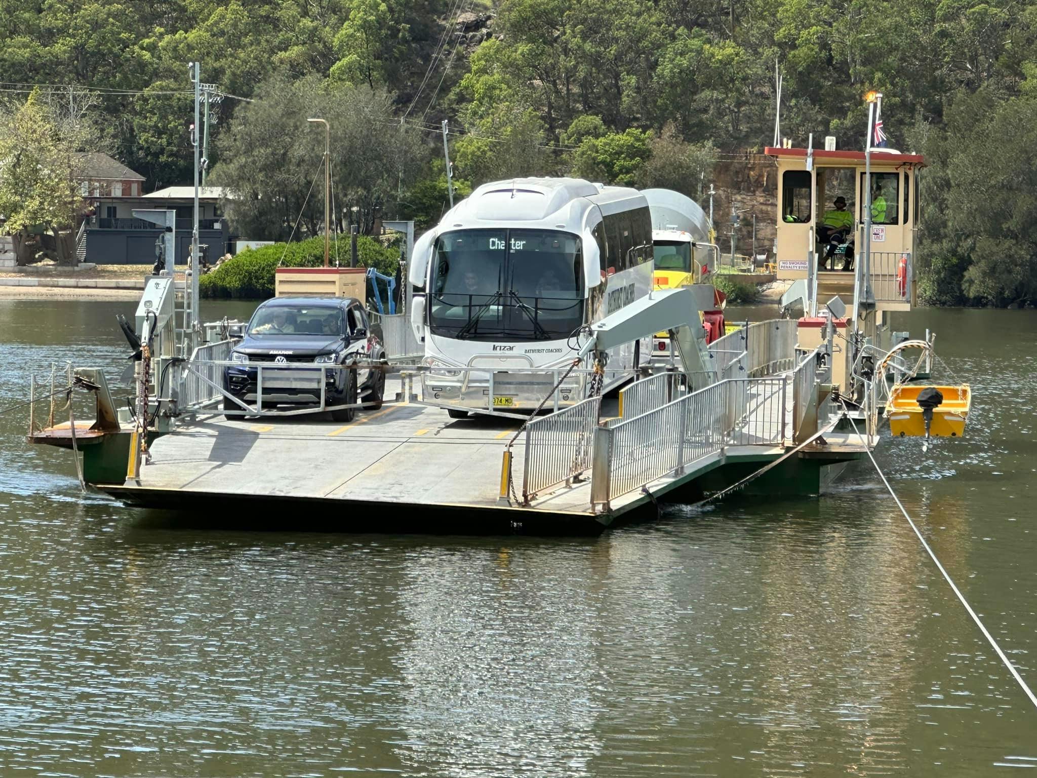 coach on ferry along river