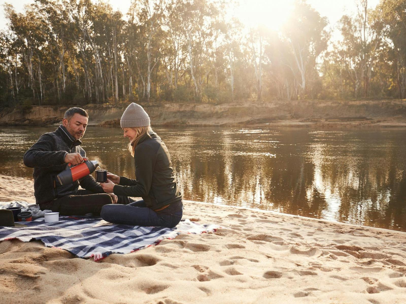 Couple having a picnic by the Murray River