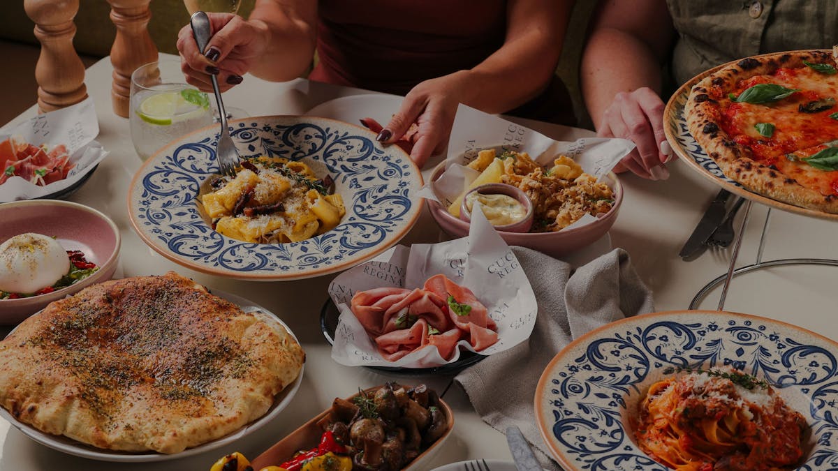 A table filled with Italian food at Cucina Regina