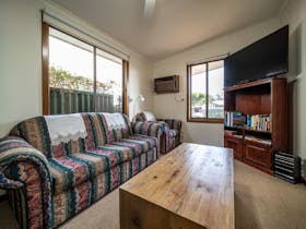 The lounge features a 50 Smart TV,  a wood fired combustion heater and an assortment of booksandDVD