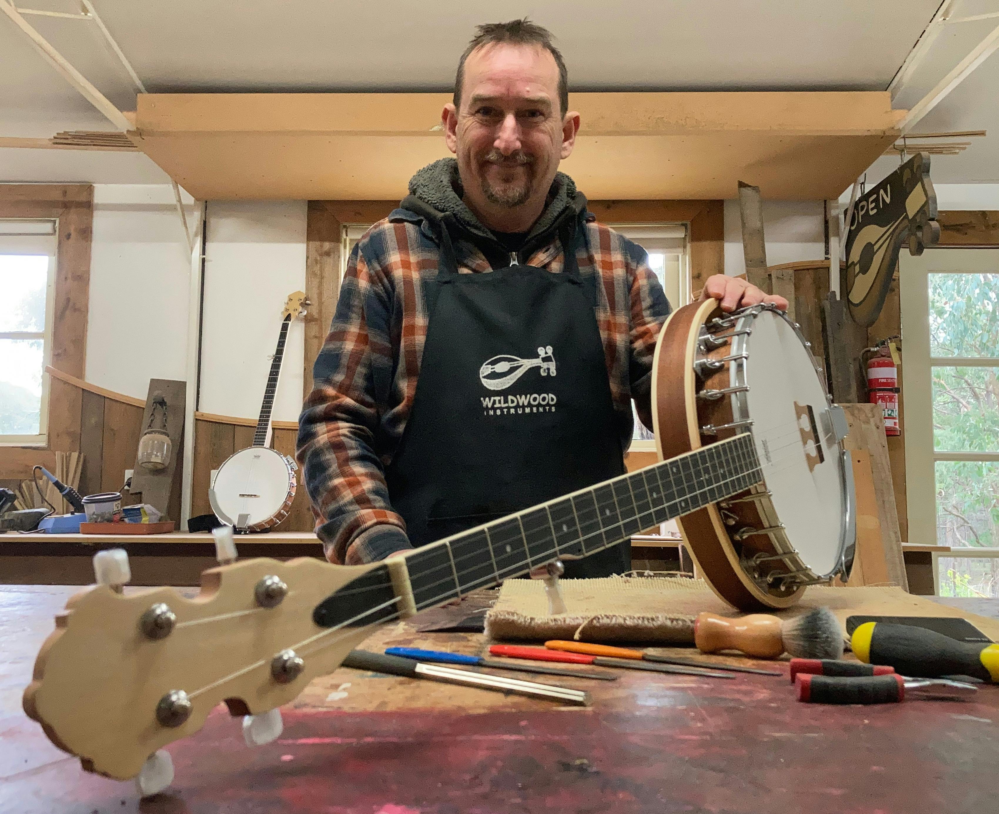 Luthier Nick Carpenter holding a Banjo