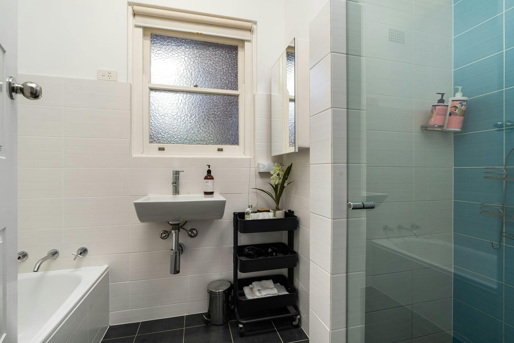 Bathroom with bath, shower and all amenities needed.