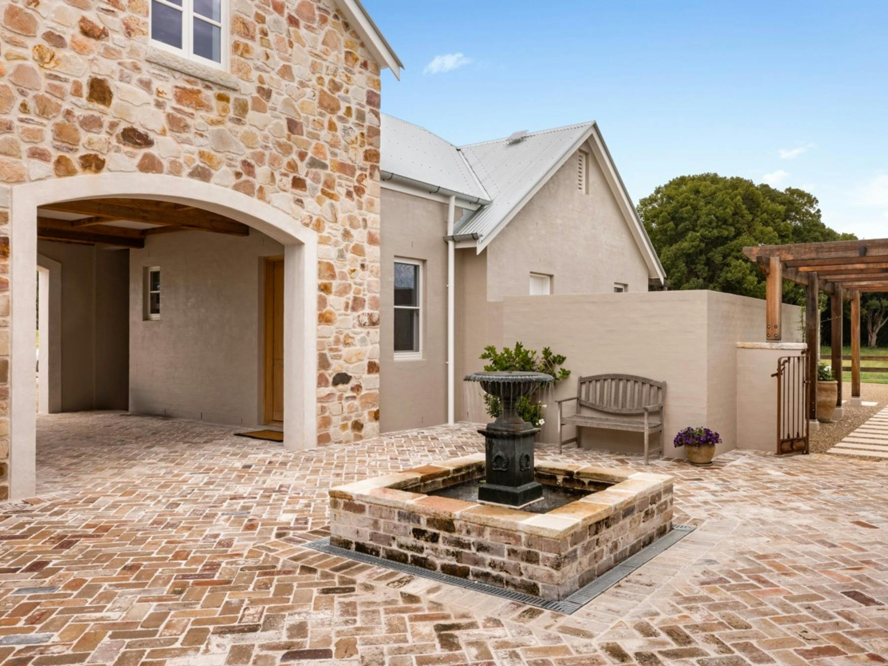 Stone courtyard with fountain and European inspired architecture at Stonehaven Estate