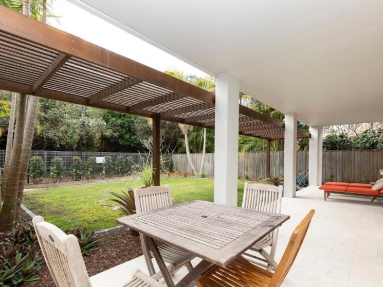 Outdoor area with dining setting and loungers