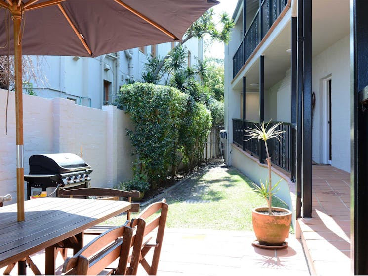 Sunny outdoor courtyard with BBQ facilities
