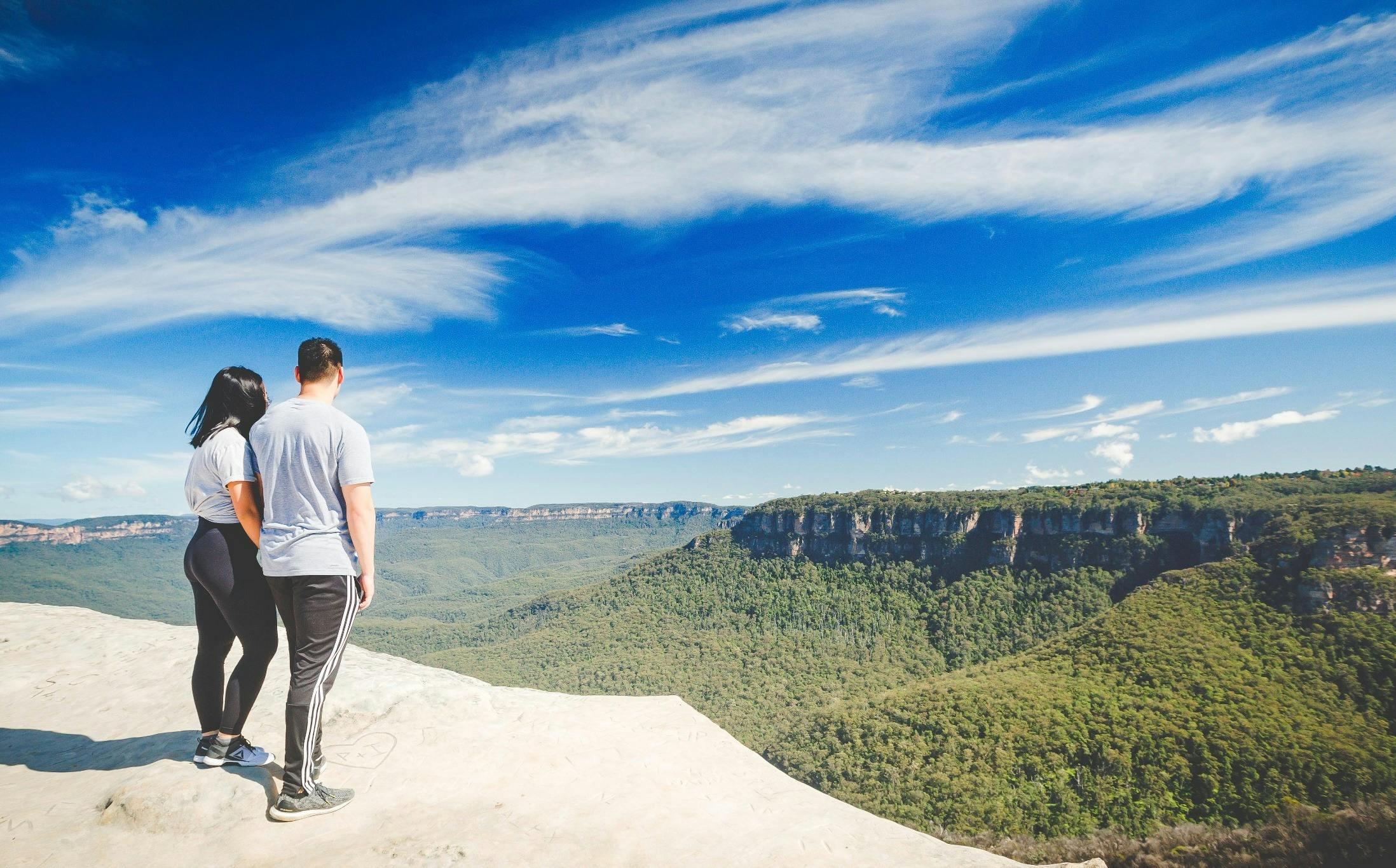 Couple at Blue Mountains cliff lookout with valley views