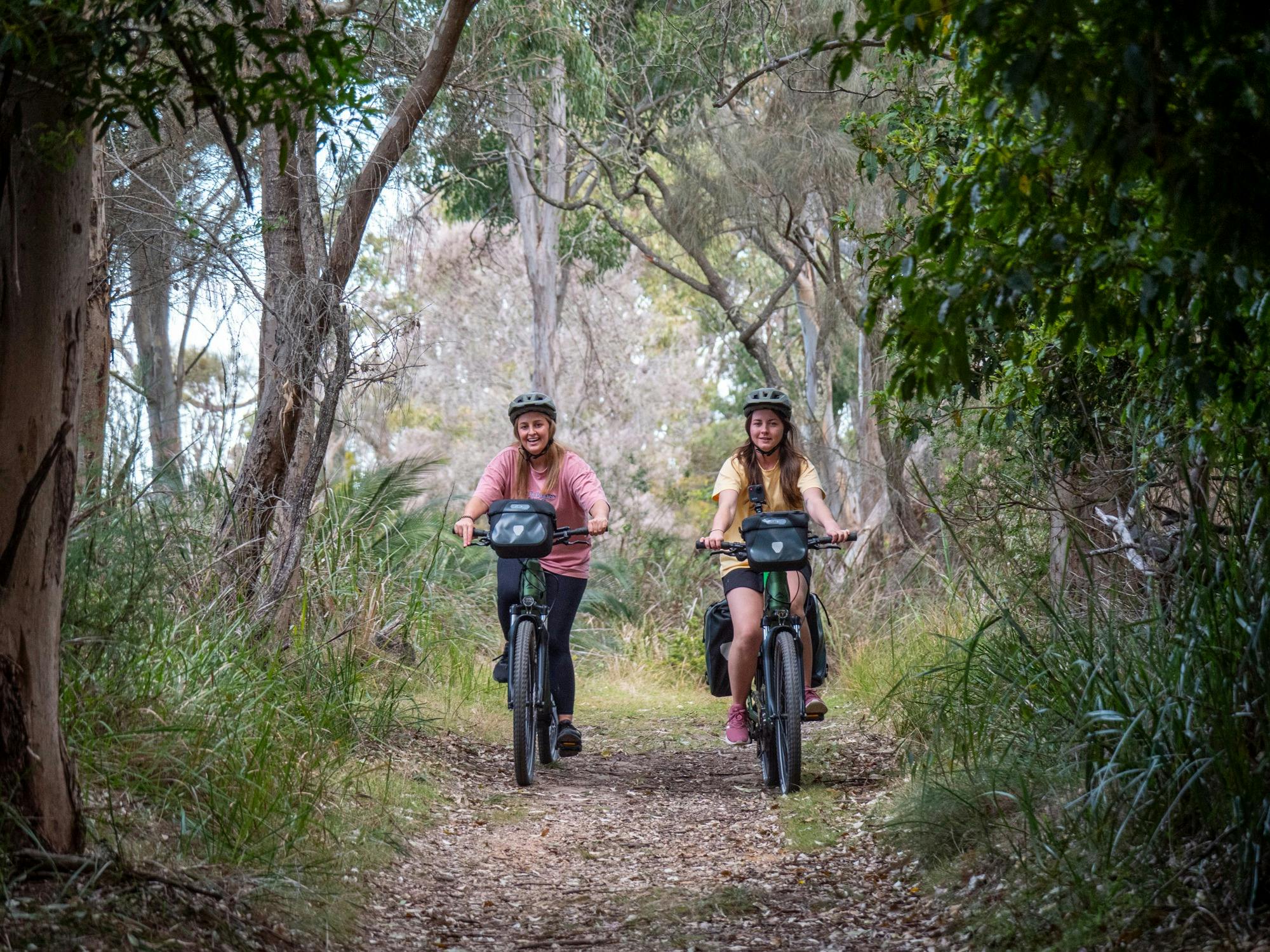 Two guests cycling in the forest of Mimosa Rocks National Park
