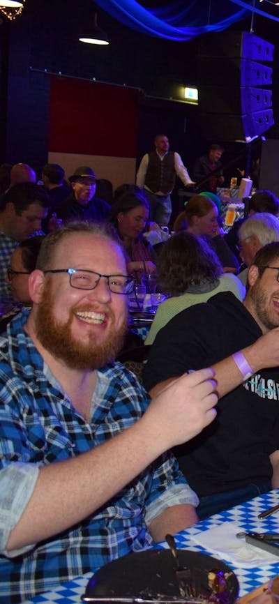 Photo of group of young men toasting a good time at Schnappsfest 2025