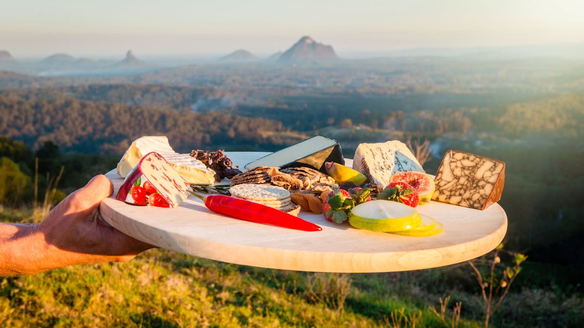 Cheese Board with 5 cheeses ans condiments over looking the Glass House mountains