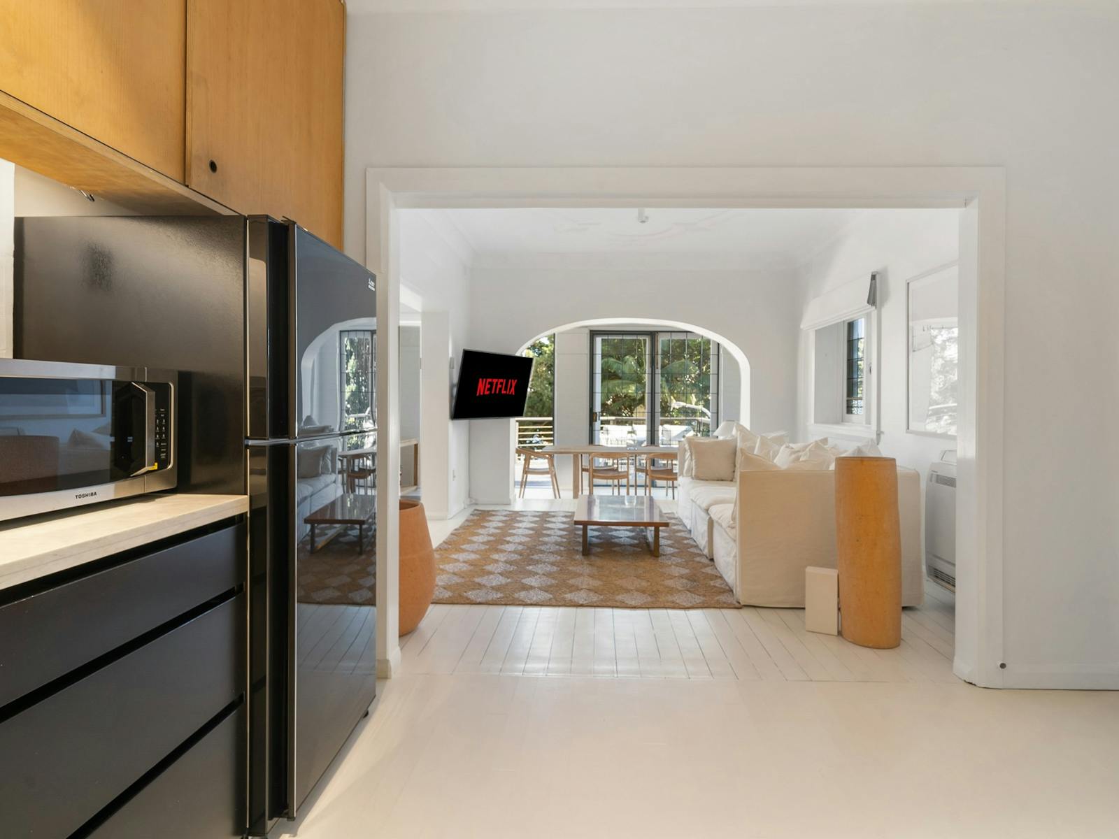 Bright kitchen with modern appliances, plants, and plenty of counter space.