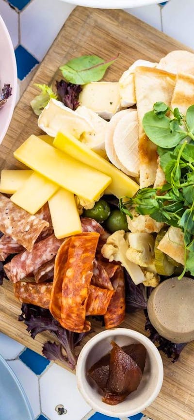 A platter of food presented on a wooden board.