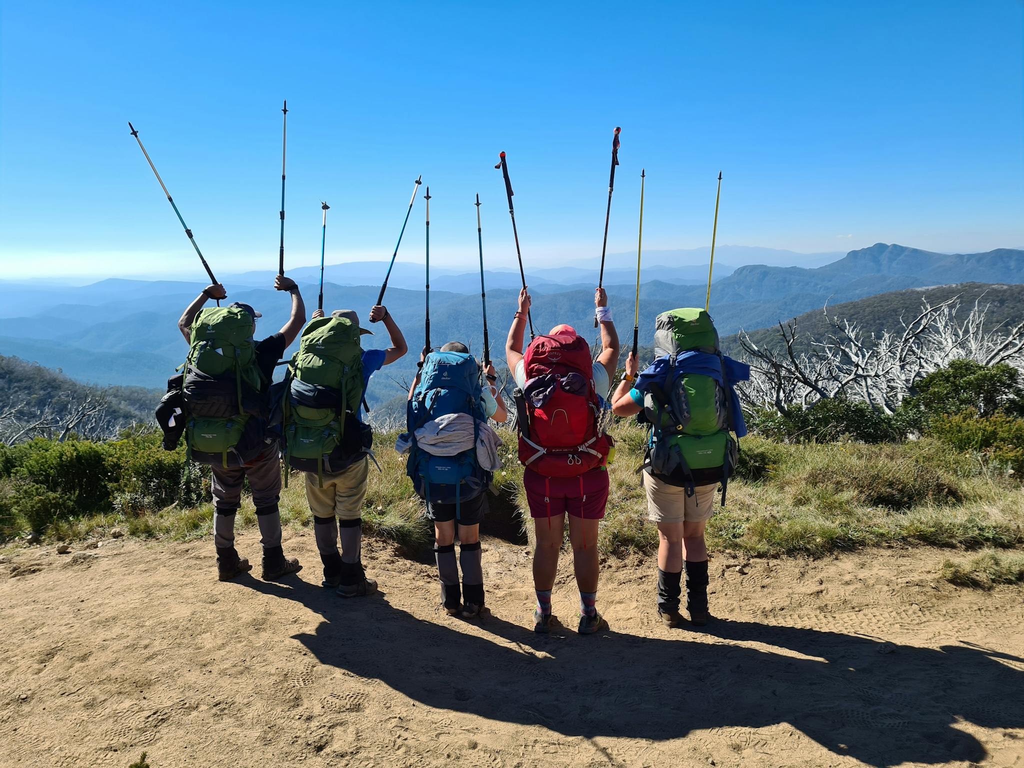 A group of hikers saluting the High Country.