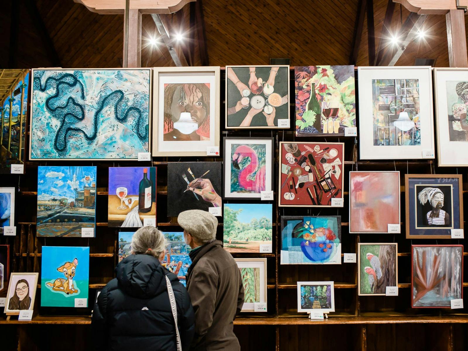A couple viewing the artworks on display