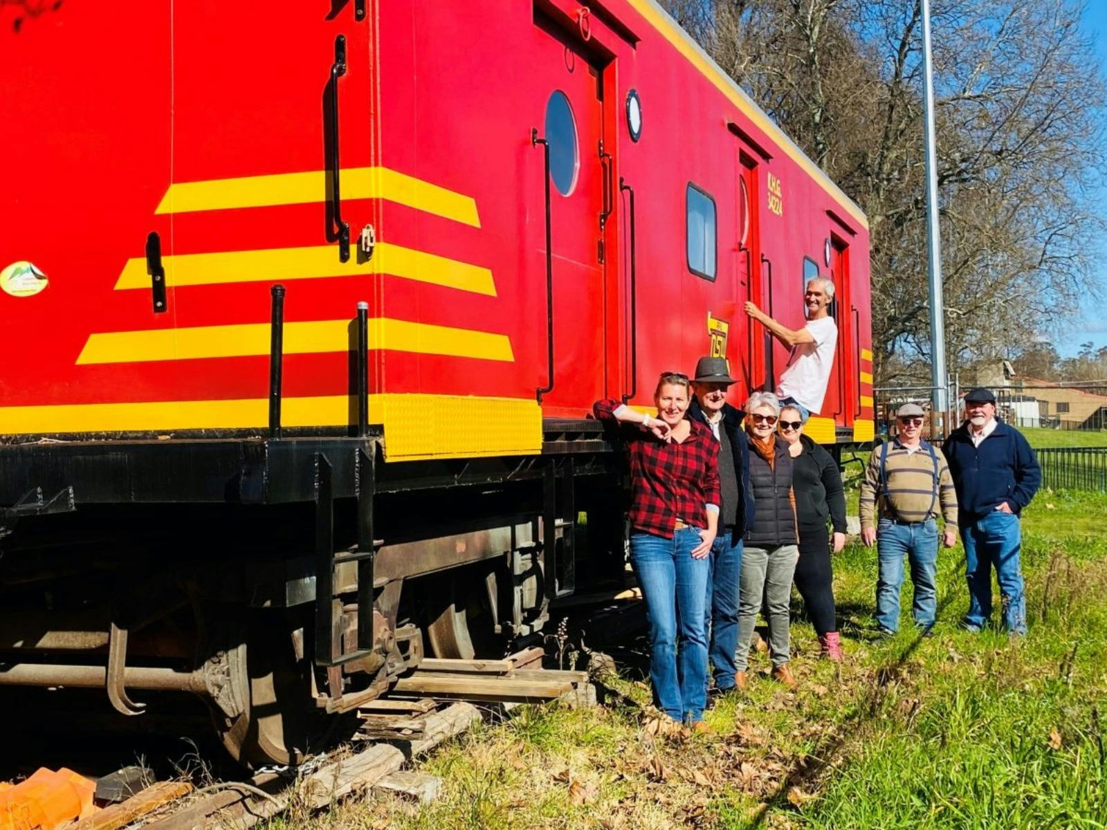 volunteers in front of train carriage