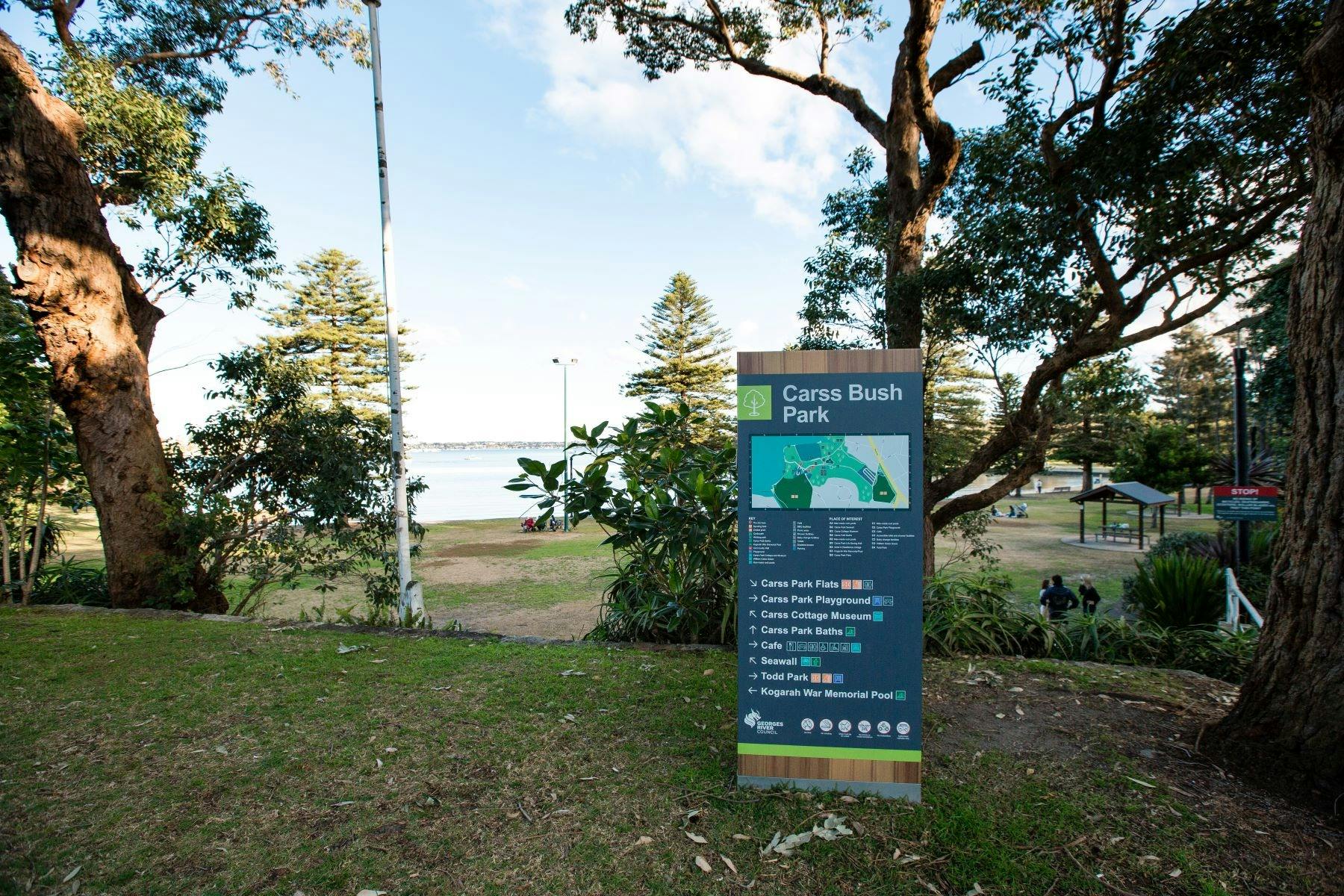 A view of Carss Bush Park  accompanied by a directory to various facilities