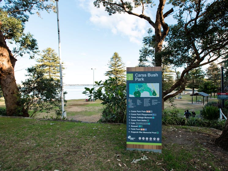 A view of Carss Bush Park  accompanied by a directory to various facilities