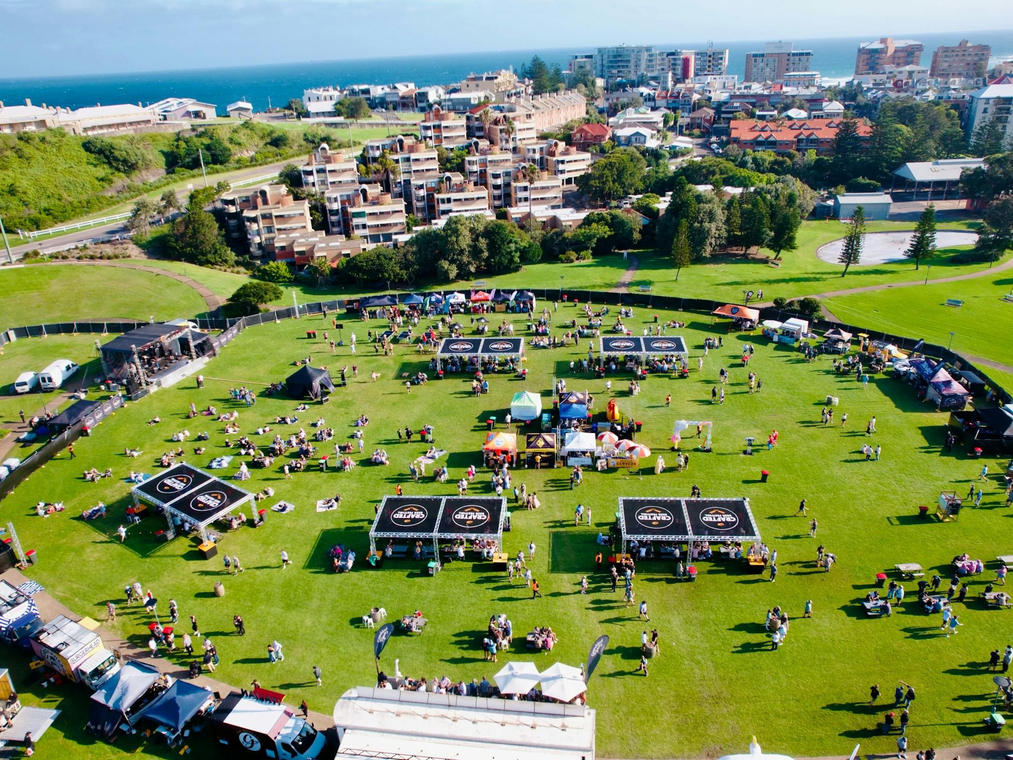 Drone image taken from above Crafted Festival of Foreshore Park with the beach in the background