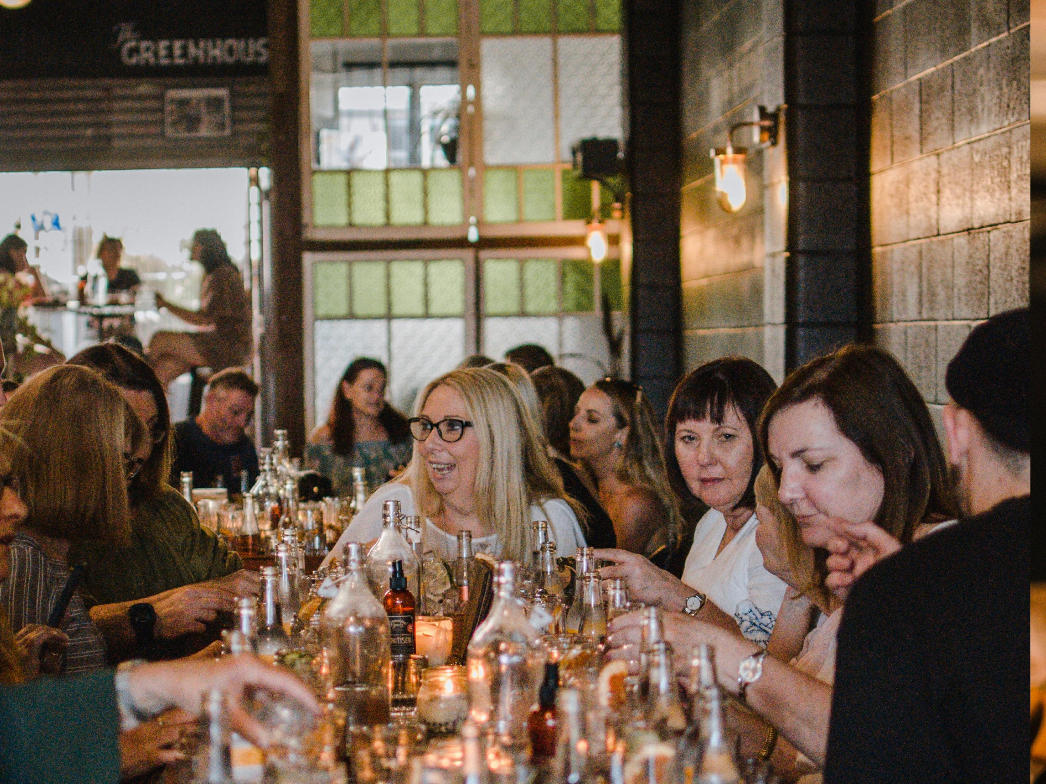 A group of people enjoying a gin tasting boards.