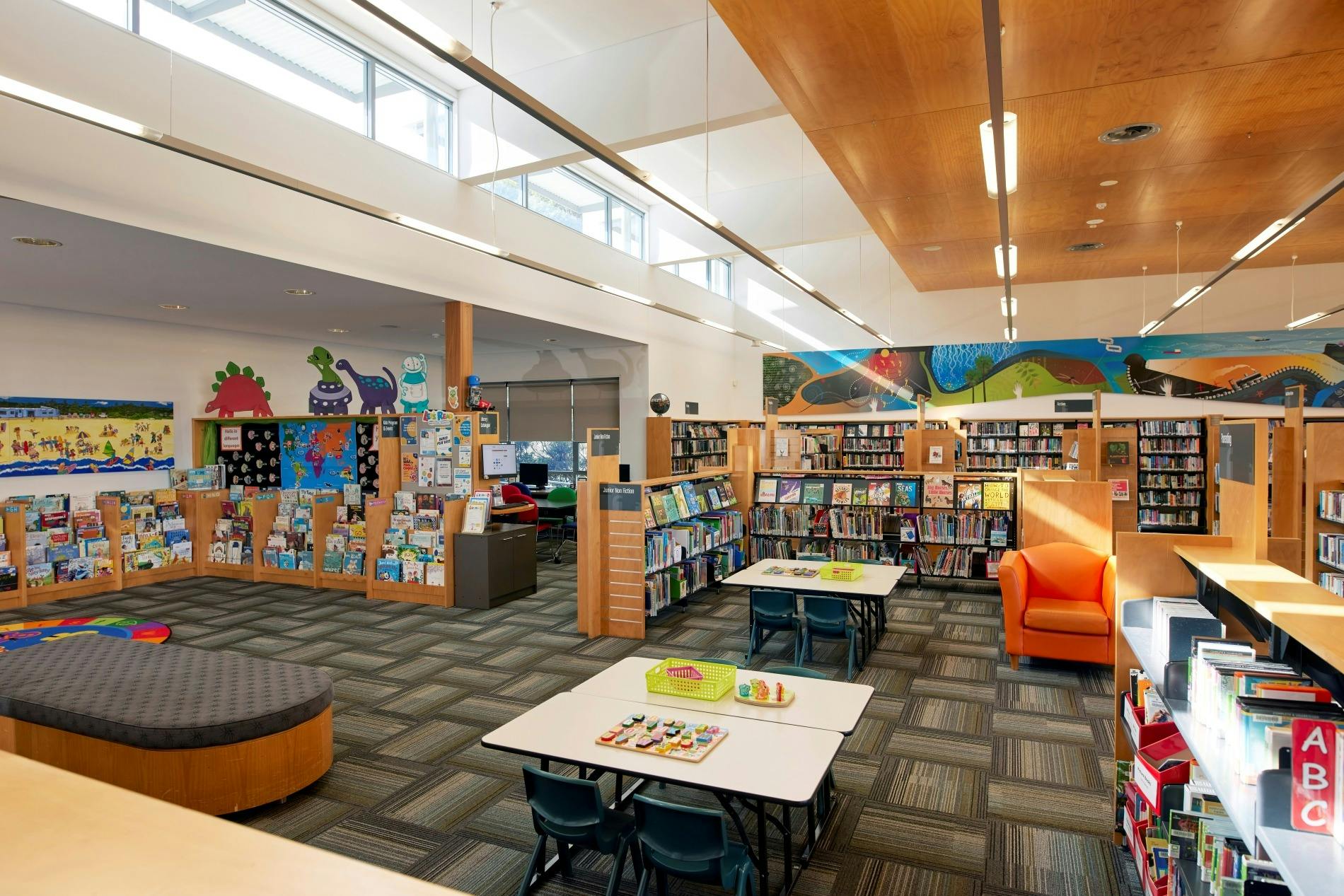 Children's section with a furniture, books and space for kids.