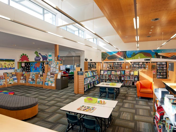 Children's section with a furniture, books and space for kids.