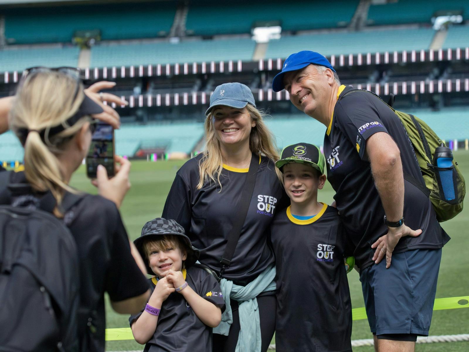 Family being photographed at the SCG during Step Out for Cancer