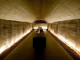 Wine tours taking people through concrete tunnels used to store wine in a cooler climate.